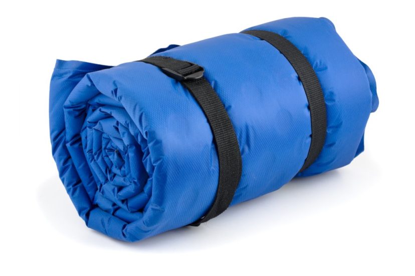 Rolled blue inflatable camping bed roll isolated on white