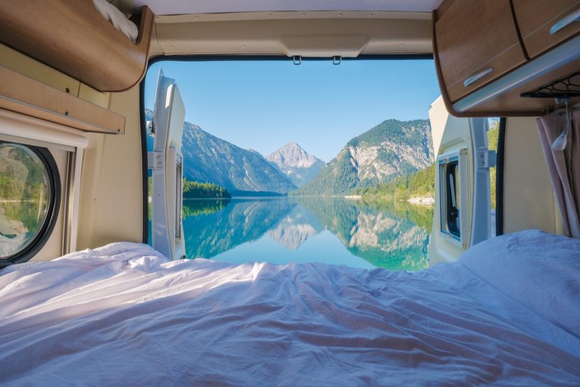 Embracing nature beauty from a cozy camper van in Plansee, Austria on a bright morning