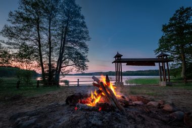 Bonfire at dusk by the lake, summer in Poland